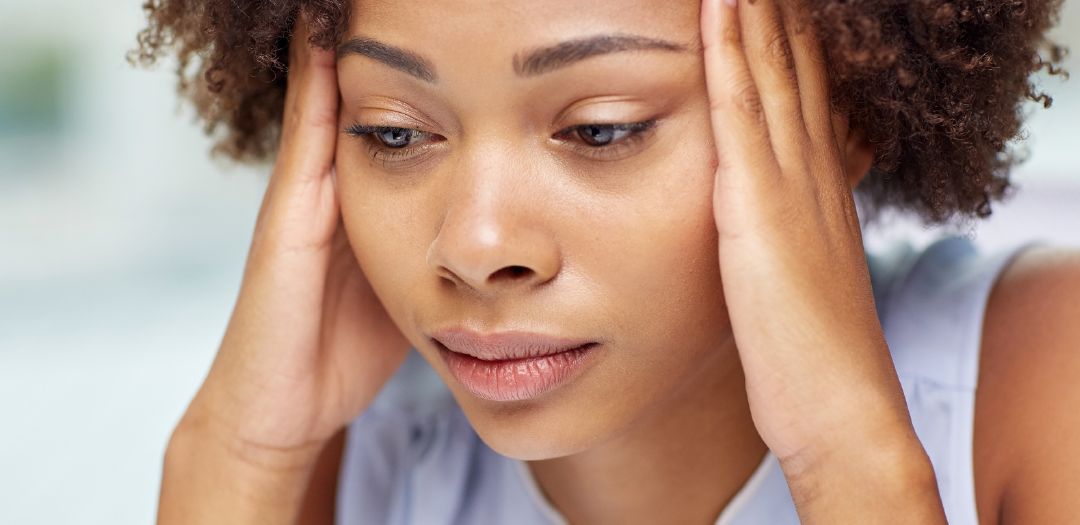 lady with a headache from Air Conditioner