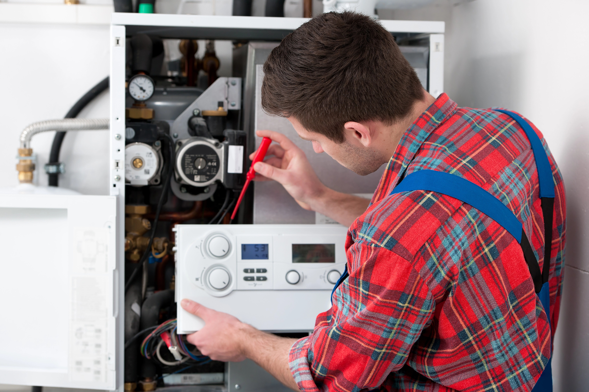 Technician repairing a boiler - boiler repair or replacement