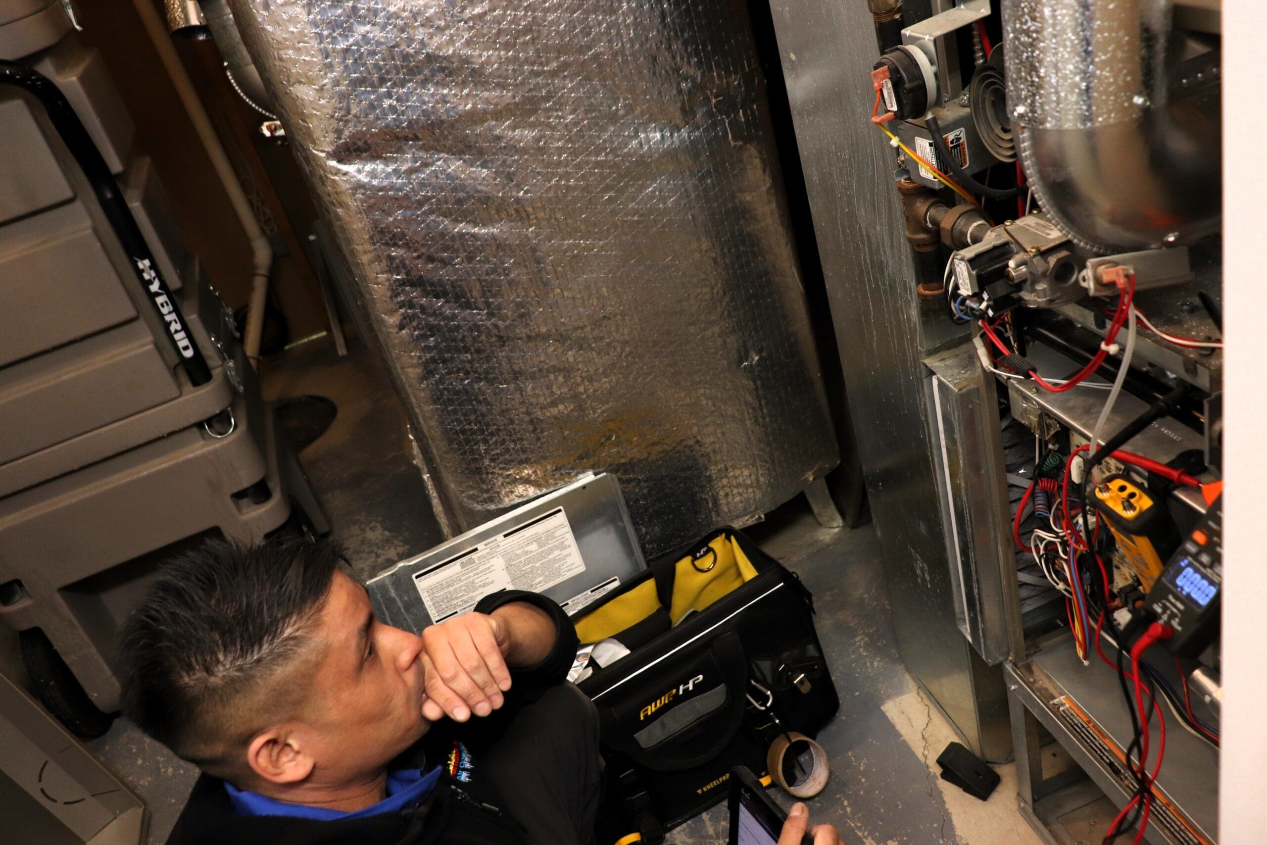 A technician investigating furnace issue