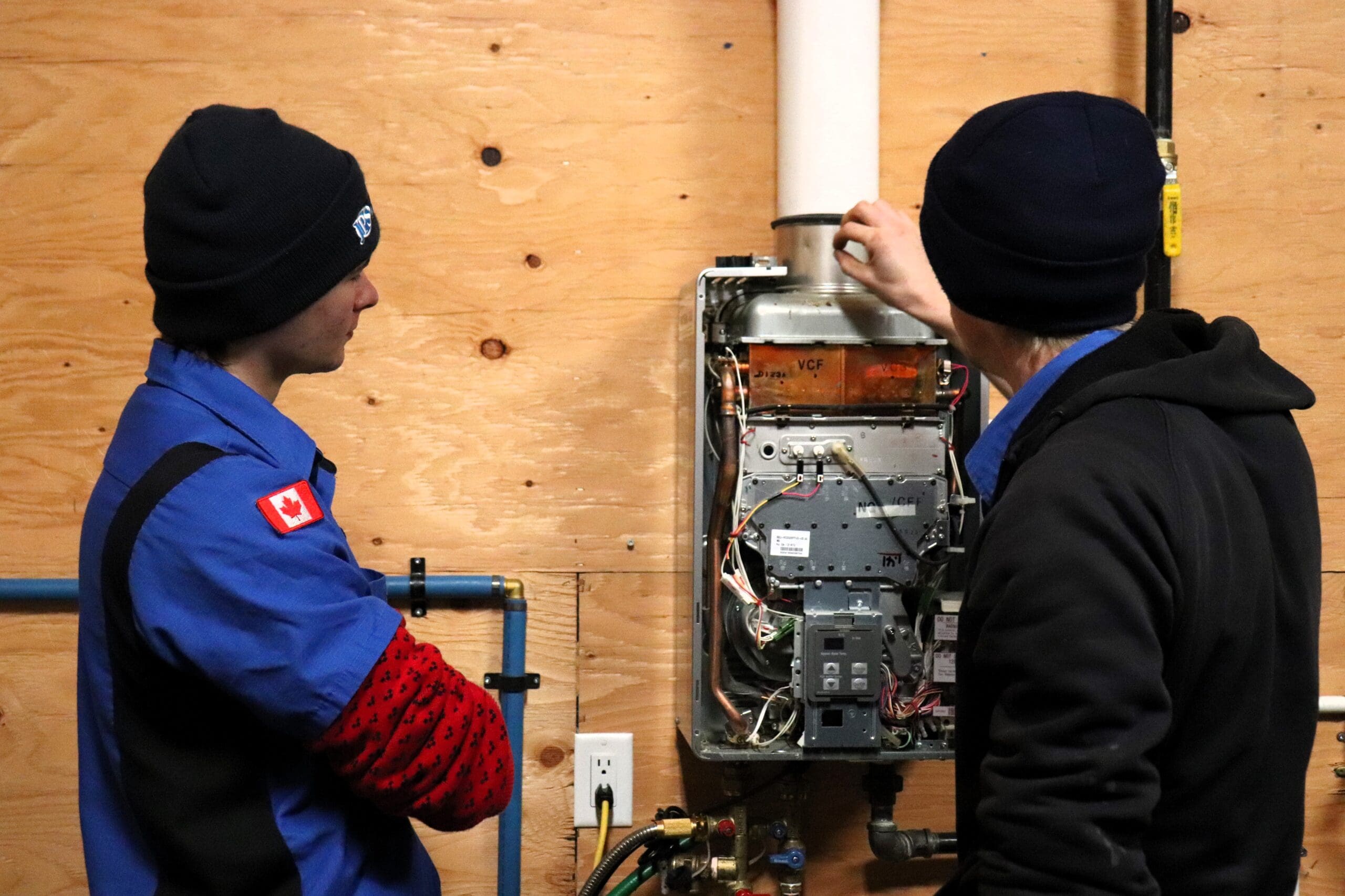 JPS technicians working on a tankless water heater